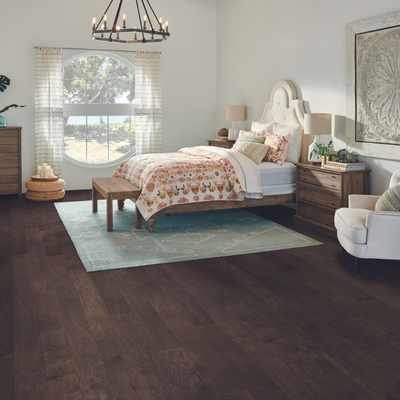 dark hardwood flooring in bedroom with mid century modern vibes